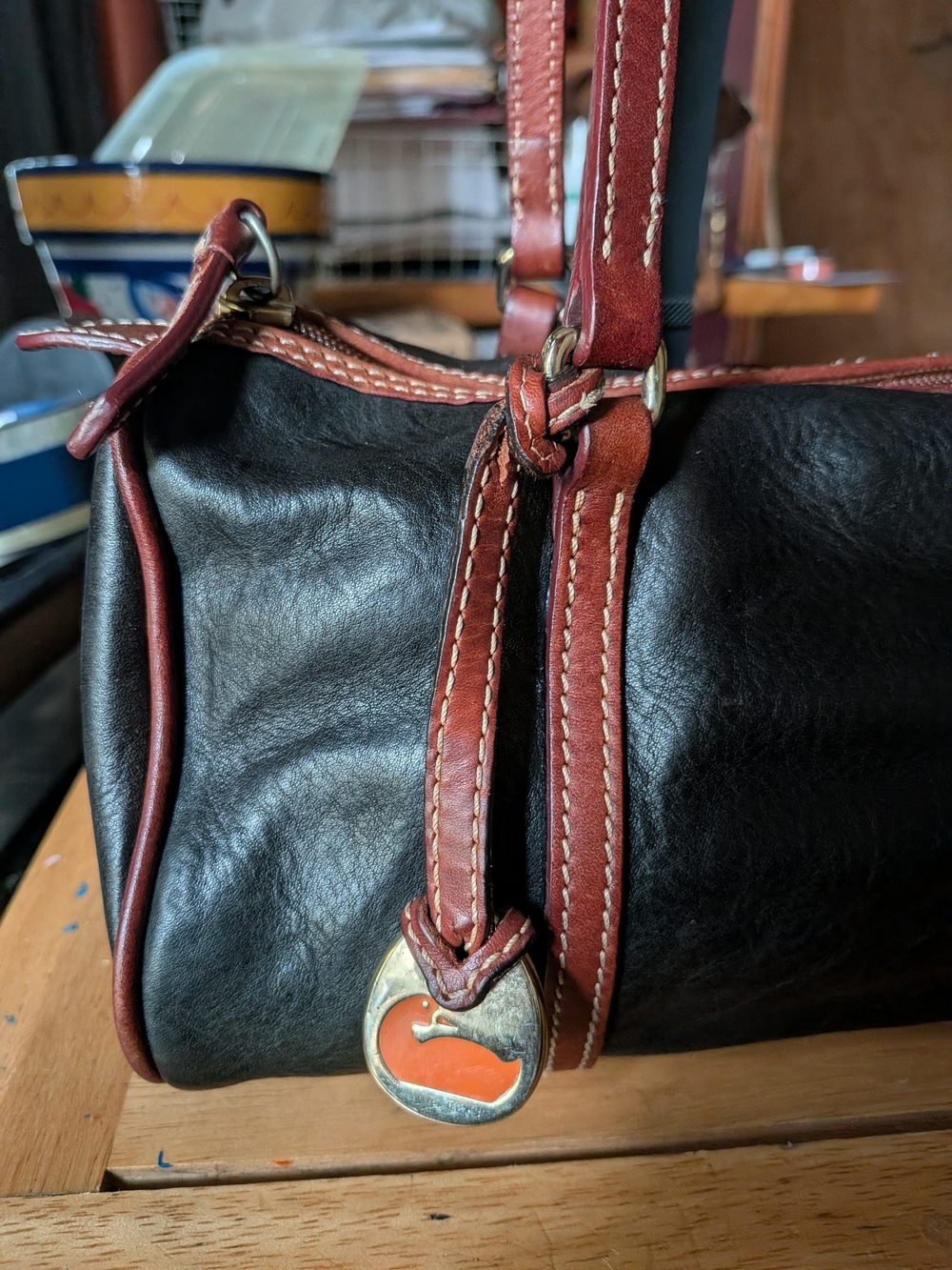 Dooney & Bourke Black Leather Barrel Bag with Brown Trim and Gold Hardware - Picture 2 of 7